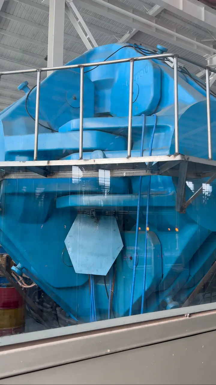 Large blue production equipment inside the factory.