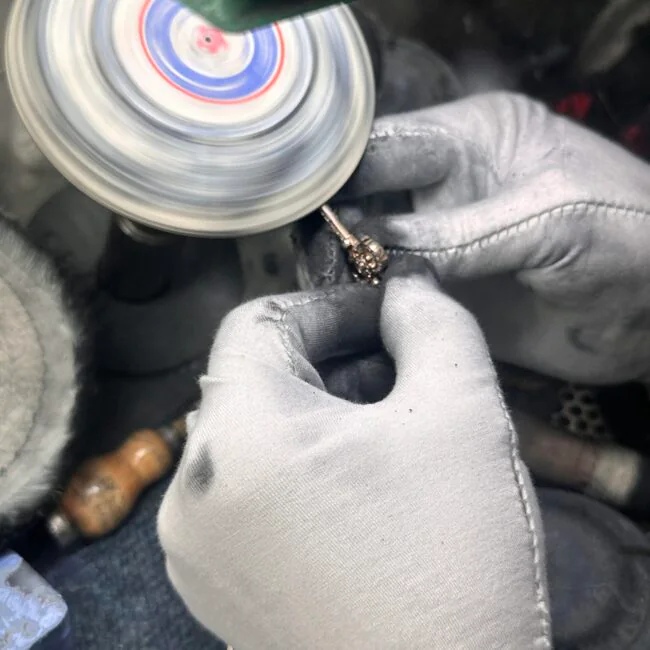 Jeweler polishing a custom ring at the workbench