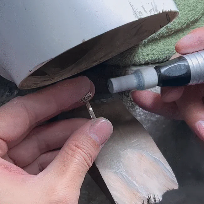 Jeweler polishing the surface of a ring by hand